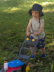 Our nephew William happily "mowing" the lawn.